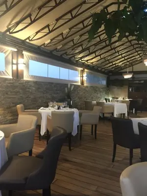 a dining room with white tables and chairs at Vizzavona Piscine in Ajaccio