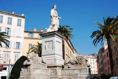 a statue of a woman on top of a clock at Vizzavona Piscine in Ajaccio