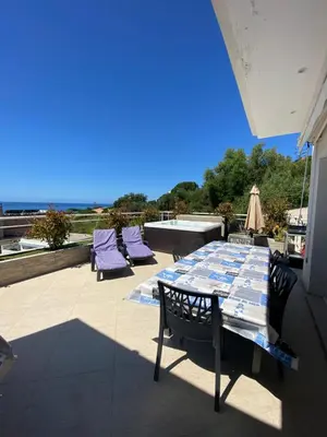 a table and chairs sitting on a patio at VIzzavona piscine et jacuzzi in Ajaccio