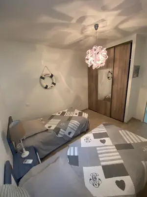 a bedroom with a bed and a chandelier at VIzzavona piscine et jacuzzi in Ajaccio