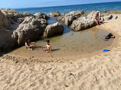 three people playing in the sand on the beach at Evasion Marine - T2 Vue mer - Terrasse - Plage à pied in Ajaccio