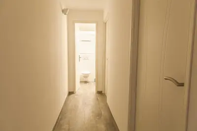 a hallway with a toilet in a white room at Appartement Gialla in Porto-Vecchio