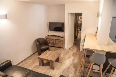 a living room with a couch and a television at Appartement Gialla in Porto-Vecchio