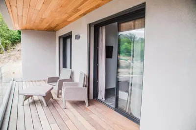 a balcony with a table and chairs on a deck at Appartement Gialla in Porto-Vecchio