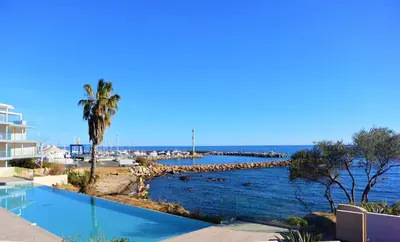 a swimming pool with a view of the ocean at TADO in Kamiesch