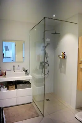 a bathroom with a glass shower and a sink at TADO in Kamiesch