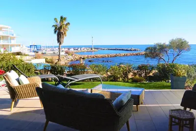 a patio with chairs and a view of the ocean at TADO in Kamiesch