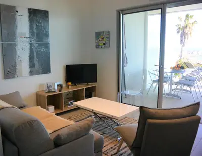 a living room with a couch and a table at TADO in Kamiesch