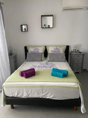 a bed with two pillows on it in a bedroom at Studio Marymer in Cervione