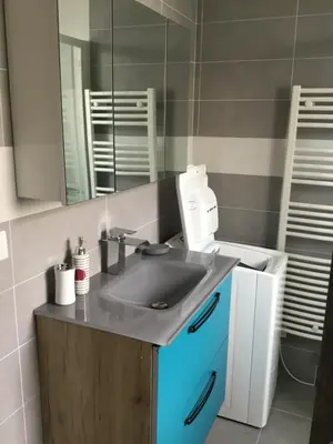 a bathroom with a sink and a mirror at Studio Marymer in Cervione