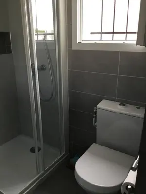 a bathroom with a toilet and a shower with a window at Studio Marymer in Cervione