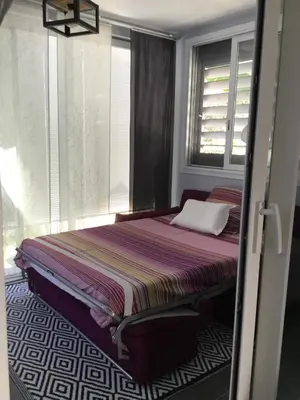 a bedroom with a bed in a room with a window at Studio Marymer in Cervione