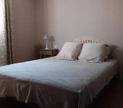 a bed with white sheets and pillows in a bedroom at Casa Myrta 3 étoiles in Porto-Vecchio