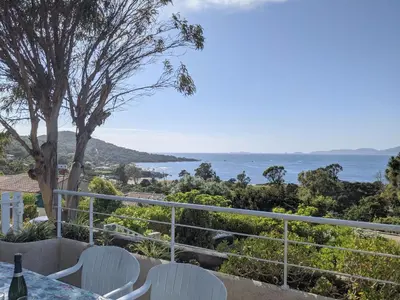 a view of the ocean from a table and chairs at Appartements L'Acacia - plage d'Argent à 300m in Coti-Chiavari