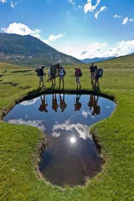 a group of people standing around a small pond at T2 au coeur de Porticcio - Vue mer Imprenable ! in Grosseto-Prugna