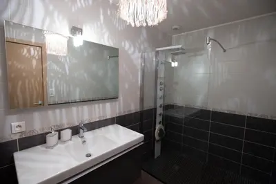 a bathroom with a sink and a mirror and a shower at T2 au coeur de Porticcio - Vue mer Imprenable ! in Grosseto-Prugna