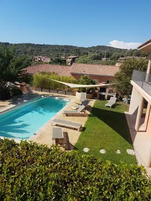 a view of a swimming pool with chaise lounges and a resort at sci marie dominique in Olmeto