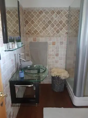 a bathroom with a glass sink and a tub at sci marie dominique in Olmeto