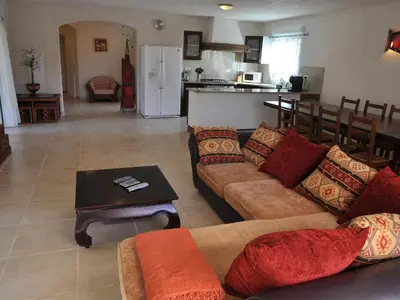 a living room with a couch and a table at Villa in Moriani-Plage with Sea View in San-Nicolao