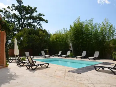 a group of lounge chairs and a swimming pool at Villa in Moriani-Plage with Sea View in San-Nicolao