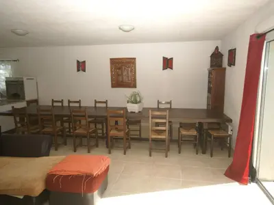 a dining room with a large wooden table and chairs at Villa in Moriani-Plage with Sea View in San-Nicolao