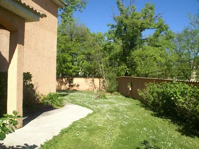 a yard with a fence and a sidewalk at Villa in Moriani-Plage with Sea View in San-Nicolao