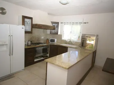a kitchen with a white refrigerator and a counter top at Villa in Moriani-Plage with Sea View in San-Nicolao