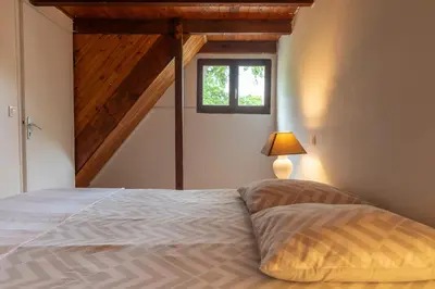 a bedroom with a large bed with a window at Palauma Plage in Sari Solenzara
