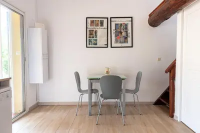 a dining room with a table and chairs at Palauma Plage in Sari Solenzara