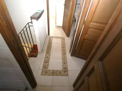 a hallway with a tile floor with a letter on it at Holiday Home Moriani-Plage with Pool in San-Nicolao