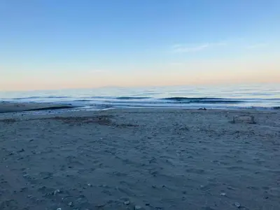 a sandy beach with the ocean in the background at Holiday Home Moriani-Plage with Pool in San-Nicolao