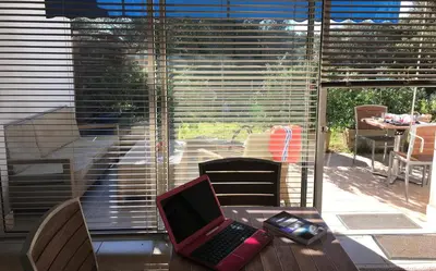 a laptop computer sitting on a table in front of a window at Résidence hôtelière A TRAMA in Bonifacio