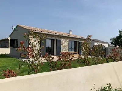 a house with a fence in front of it at Maison Corse in Aléria