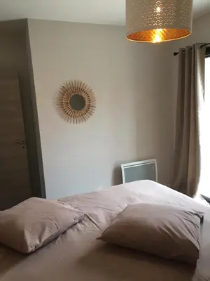 a bedroom with a bed with a mirror on the wall at Maison Corse in Aléria