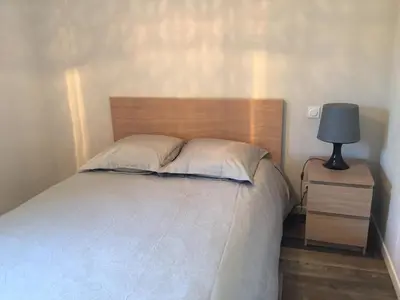 a bedroom with a bed and a lamp on a nightstand at Maison Corse in Aléria