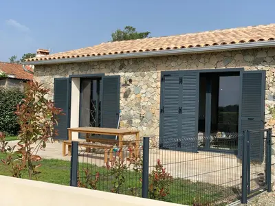 a house with a fence in front of it at Maison Corse in Aléria