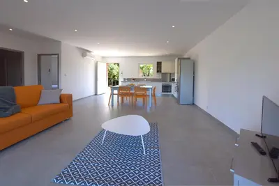 a living room with a couch and a table at SARL valinco locations in Olmeto