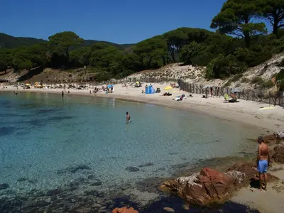 a beach with a bunch of people in the water at Riverside Home in Folelli in Penta-di-Casinca