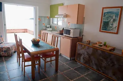 a small kitchen with a table and a microwave at Résidence Villa Nova in Tiuccia
