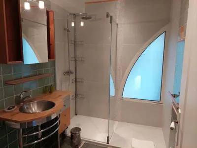 a bathroom with a sink and a glass shower at Résidence Villa Nova in Tiuccia