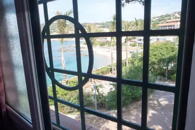 a view of a beach from a window at Résidence Villa Nova in Tiuccia