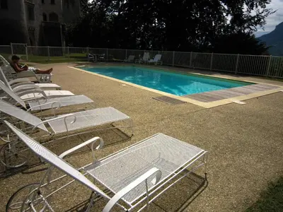a group of chairs and a swimming pool at Delightful Villa at Moriani-Plage with Garden in San-Nicolao