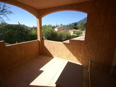 an empty balcony with a large window in a house at Delightful Villa at Moriani-Plage with Garden in San-Nicolao