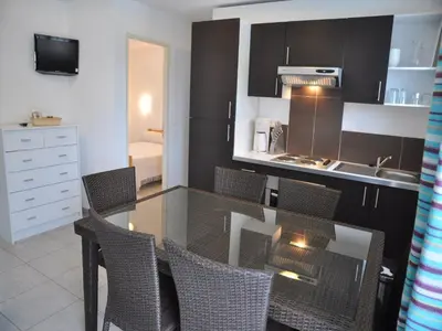 a kitchen with a table and chairs in a room at Delightful Villa at Moriani-Plage with Garden in San-Nicolao