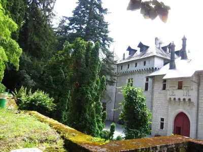 a large white castle with a red door at Delightful Villa at Moriani-Plage with Garden in San-Nicolao
