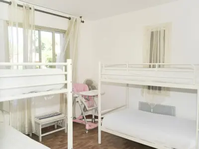 a room with three bunk beds and a window at Villa in Moriani-Plage by the Sea in San-Nicolao