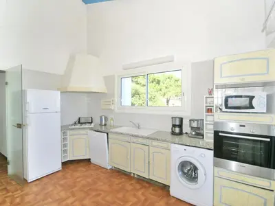 a kitchen with a washer and dryer and a window at Villa in Moriani-Plage by the Sea in San-Nicolao