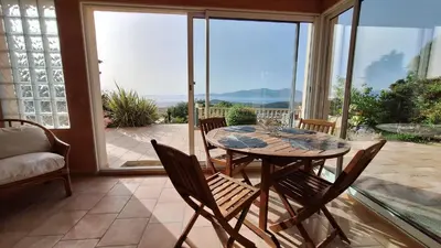 a dining room with a table and chairs on a patio at Casa Mina in Pietrosella