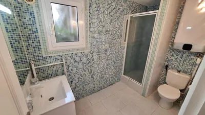 a bathroom with a toilet and a sink and a shower at Casa Mina in Pietrosella