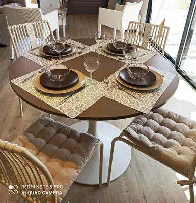 a dining room table with plates and glasses on it at Sagone in Vico